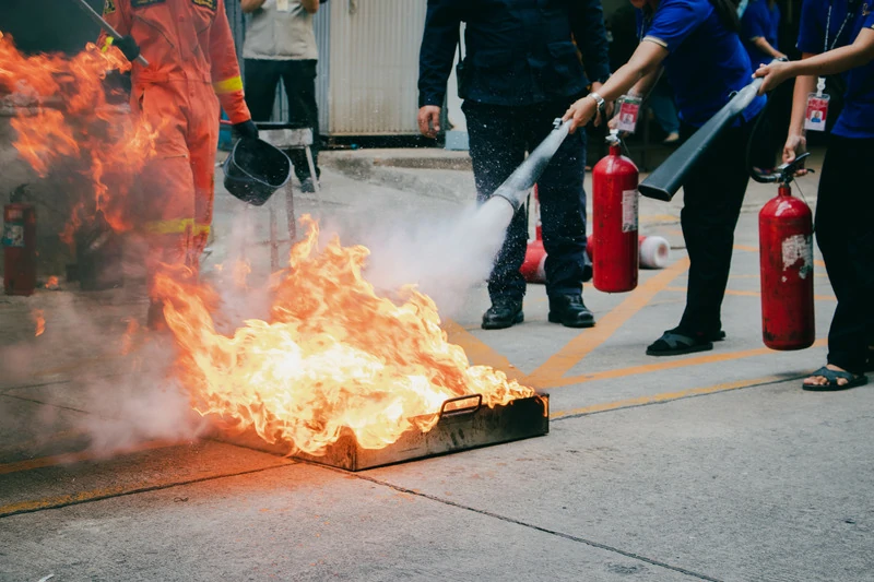 Participants practicing fire extinguisher use during fire safety training